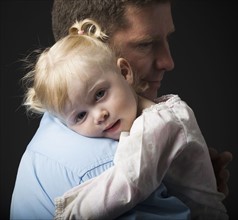 Daughter hugging father. Photographer: Mike Kemp