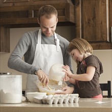 Father and daughter baking. Photographer: Mike Kemp