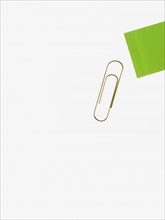 Paper clip and green paper. Photographer: David Arky