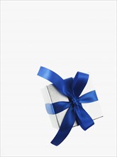 Gift and blue ribbon. Photographer: David Arky