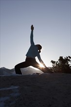 Woman doing yoga outdoors. Photographer: Dan Bannister