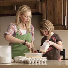 Mother and daughter baking. Photographer: Mike Kemp