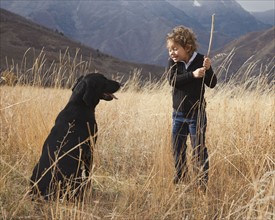 Girl playing fetch with dog. Photographer: Mike Kemp