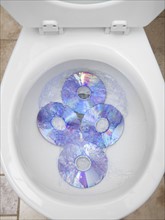 CD's in a toilet bowl. Photographer: Mike Kemp