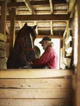 Horse and man in barn