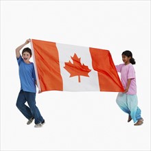 Children carrying Canadian flag. Photographer: momentimages