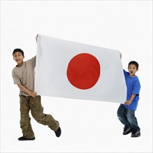 Children carrying flag. Photographer: momentimages