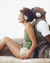 Couple wearing headphones. Photographer: momentimages