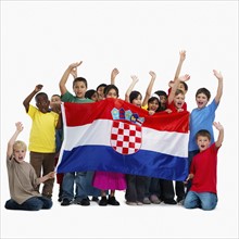 Children holding flag. Photographer: momentimages