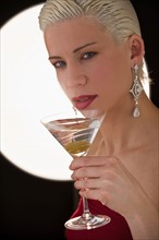 Woman drinking martini. Photographer: Daniel Grill