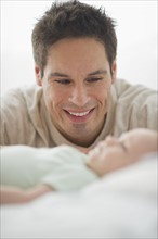 Father smiling at baby.
