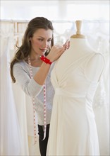 Seamstress in bridal shop.