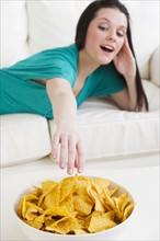 Eating tortilla chips. Photographer: Daniel Grill