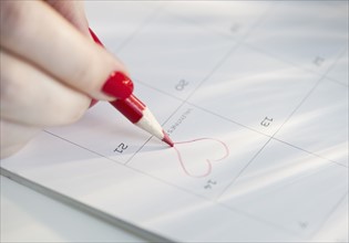 Drawing a heart on a calendar.