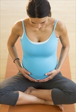 Pregnant woman doing yoga.