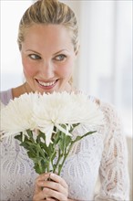 Woman holding a bouquet of white flowers.