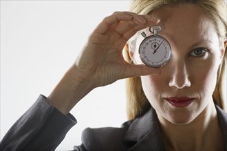 Woman holding a stopwatch.