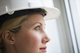 Female architect wearing a hard hat.