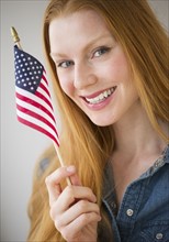Woman holding American flag.