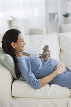 Pregnant woman resting on couch.