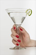 Hand holding martini glass.