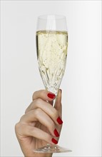 Hand holding champagne glass.