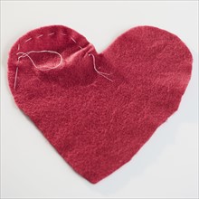 Stitched red heart. Photographe : Jamie Grill