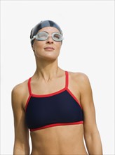 Woman wearing swimming goggles.