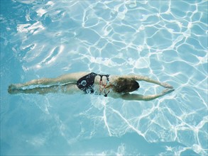 Woman swimming in pool.