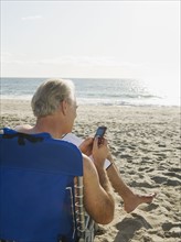Man relaxing in beach chair.