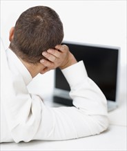 Businessman looking at computer. Photographe : momentimages