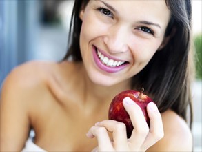 Woman eating an apple. Photographe : momentimages