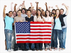 Group of people holding American flag. Photographe : momentimages