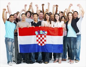 Group of people holding flag. Photographe : momentimages