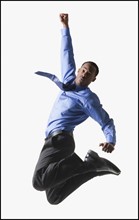 Businessman jumping. Photographe : Mike Kemp
