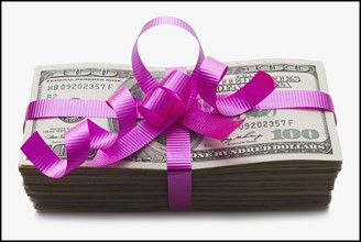 American currency tied with a pink bow. Photographe : Mike Kemp