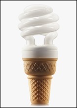 Compact fluorescent light bulb in an ice cream cone. Photographe : Mike Kemp