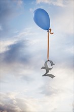 Balloon tied to a British pound symbol. Photographe : Mike Kemp