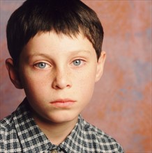 Portrait of a sad young boy. Photographe : Rob Lewine