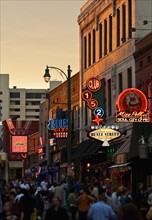 Crowd of people and buildings on Beale Street in Memphis.