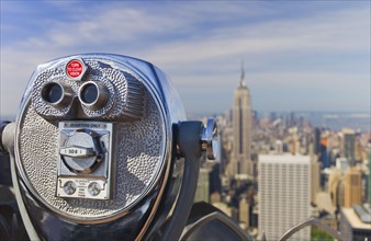 Coin operated binoculars looking out on New York City skyline.