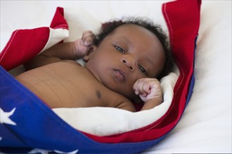 Baby wrapped in American flag. Photo : Daniel Grill