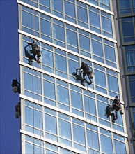 Window washers cleaning windows on skyscraper. Photo : fotog