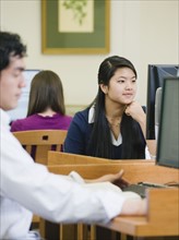 College students working in library.