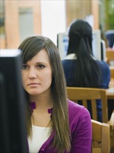 College students working in library.