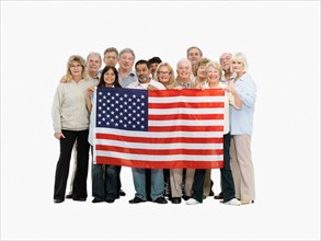 Group of people holding an American flag. Photo : momentimages
