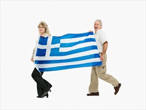 Two people carrying the Greece flag. Photo : momentimages