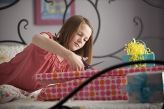 Young girl wrapping presents. Photo : Mike Kemp