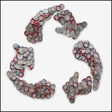 Crushed can arranged in the shape of recycle symbol. Photo : Mike Kemp