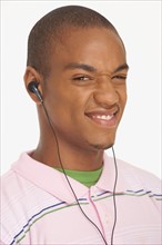 Man wearing earphones making a funny face. Photo : K.Hatt